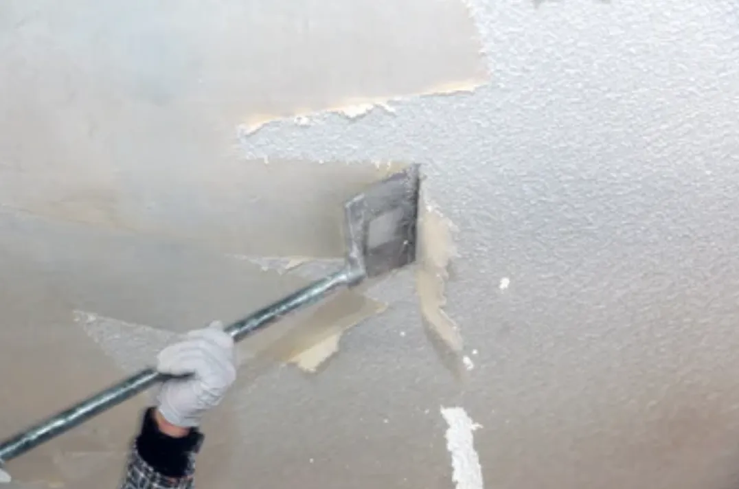 Popcorn ceiling texture being scraped off